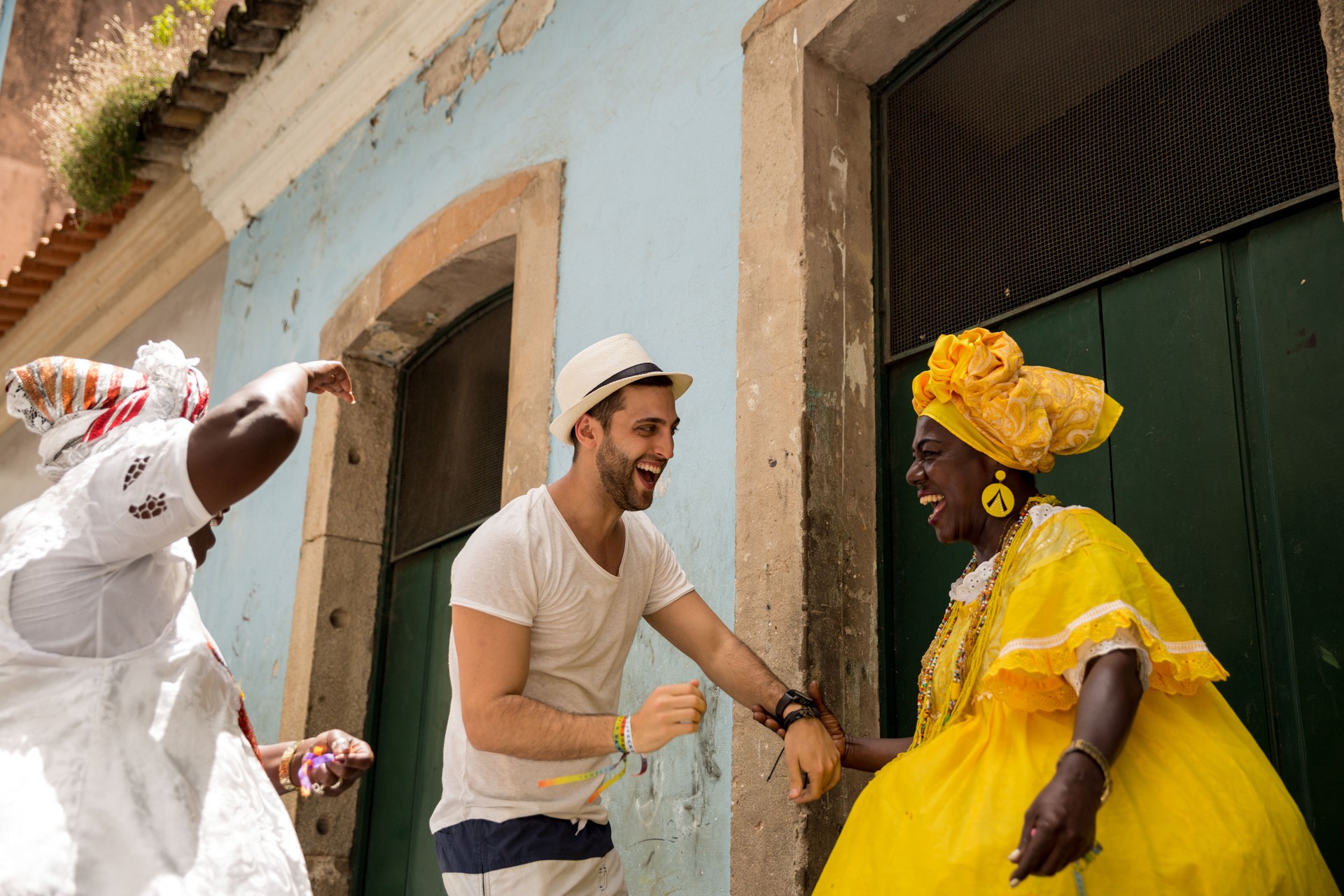 Tourist dancing with local Brazilian woman "Baiana" in Pelourinho, Salvador, Bahia, Brazil